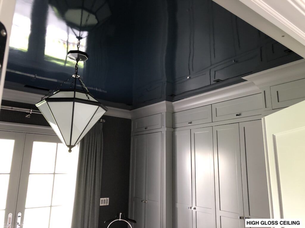 High-gloss navy ceiling and custom millwork in New Canaan, CT with reflective finish, crisp trim lines, and dramatic interior contrast