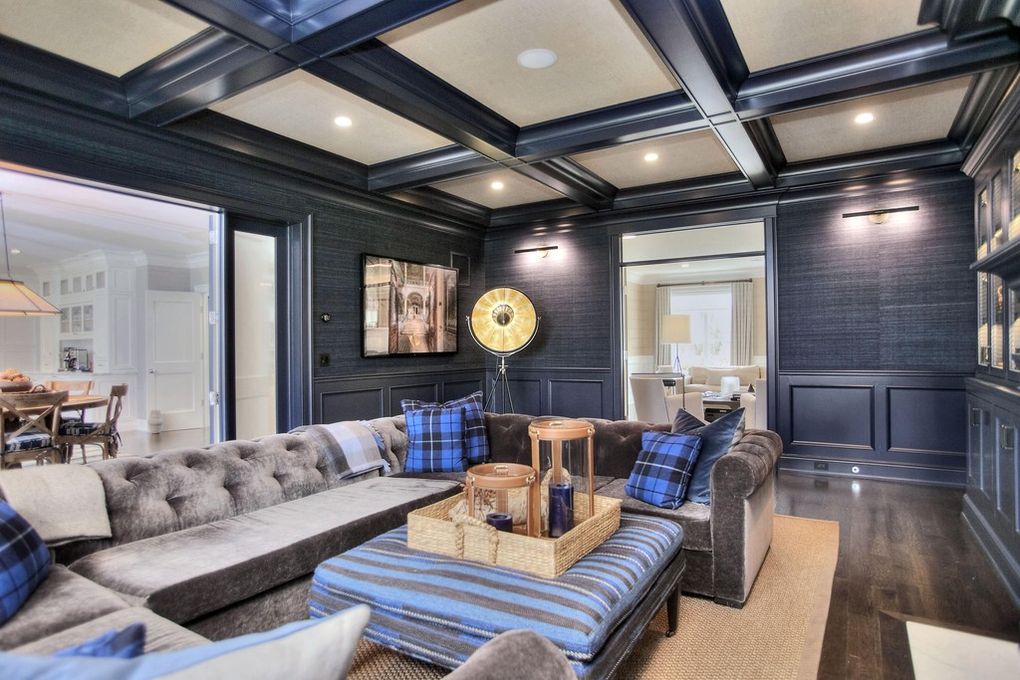 Dark paneled room in New Canaan, CT with a coffered ceiling, deep navy walls, and a dramatic custom interior finish