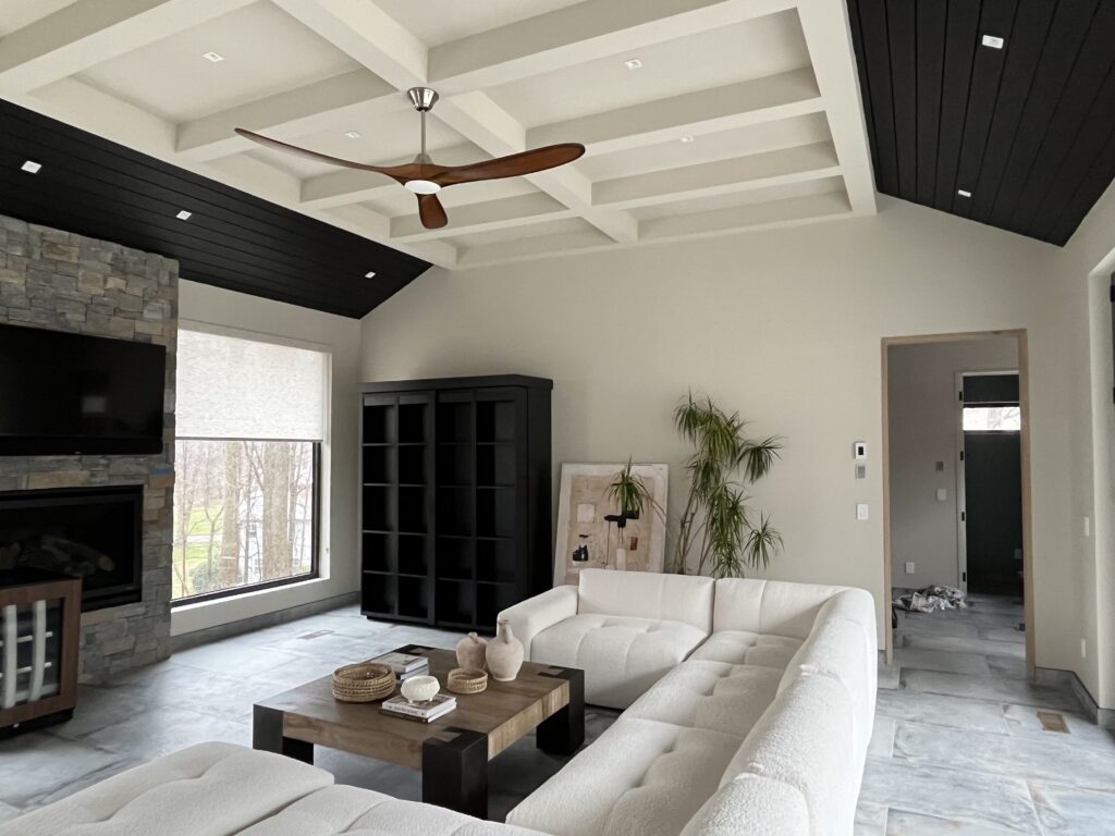 Modern living room in Stamford, CT with a white coffered ceiling, black ceiling accents, and a clean custom interior painting finish