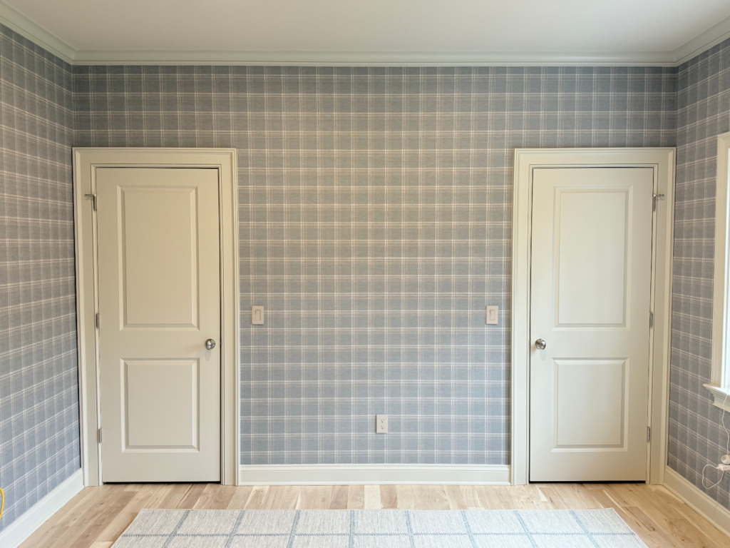 Guest room in New Canaan, CT with blue plaid walls, crisp trim, and a clean interior painting finish